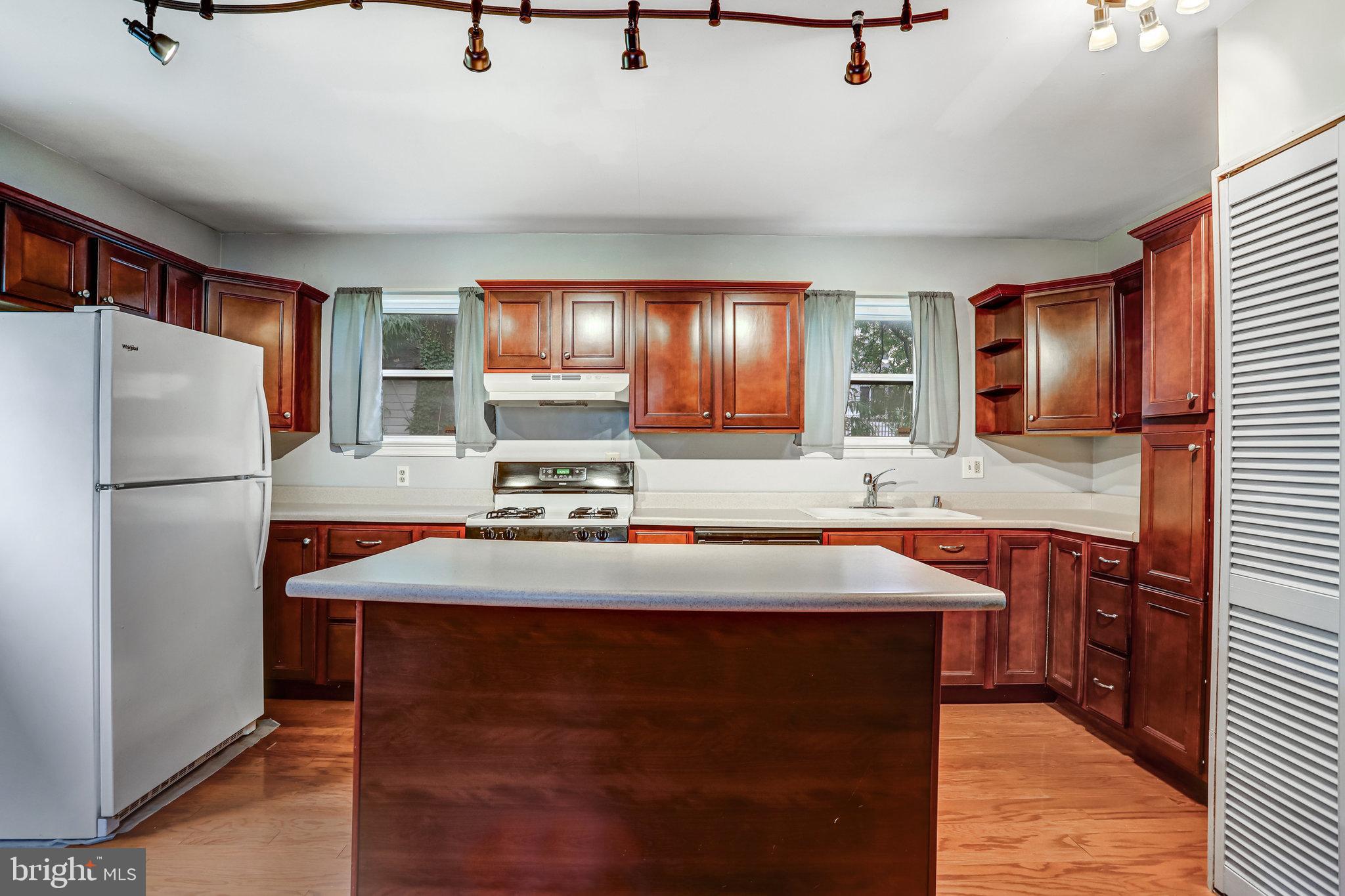 3026 Channing Street Northeast Washington, DC 20018 - Photo 9 of 24 a kitchen with stainless steel appliances granite countertop a sink refrigerator and cabinets