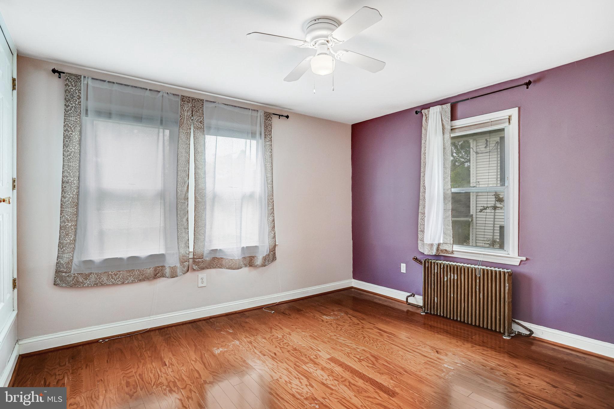 3026 Channing Street Northeast Washington, DC 20018 - Photo 10 of 24 an empty room with wooden floor and windows