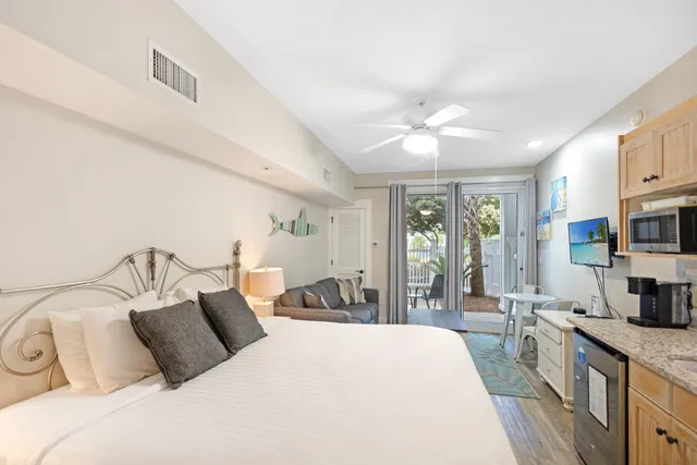 a bedroom with a large bed and a chandelier