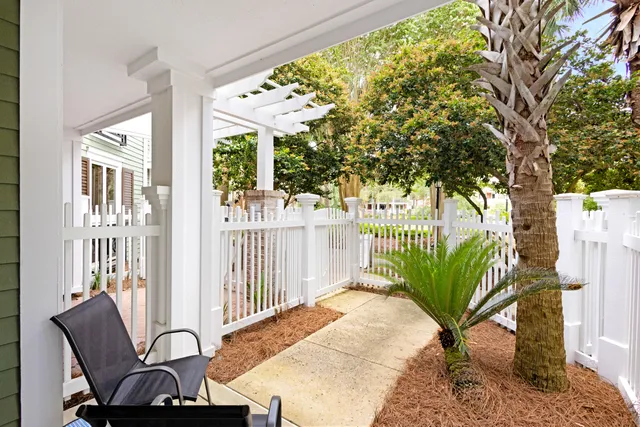 a view of a porch with furniture and a backyard