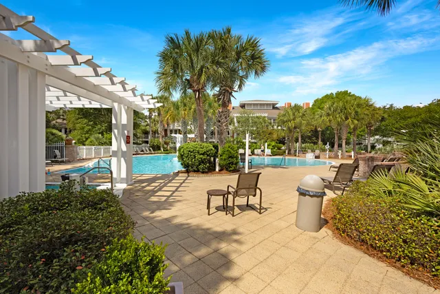 a view of a patio with couches and table and chairs and potted plants