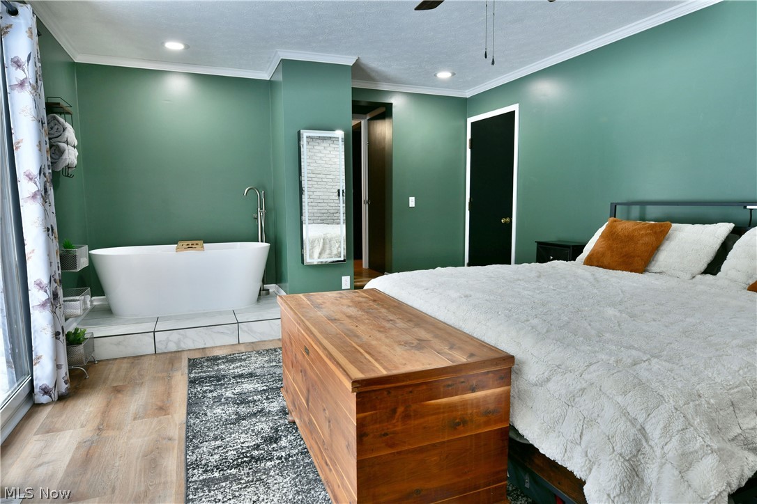 4251 Wayne Road Mantua, OH 44255 - Photo 17 of 34 Bedroom featuring light wood-style flooring, ornamental molding, recessed lighting, ceiling fan, and a textured ceiling