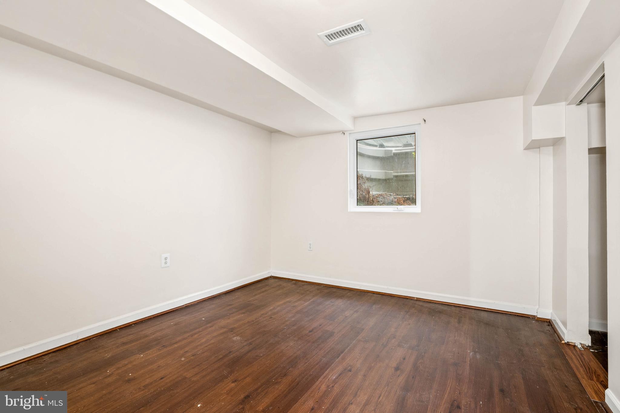 10149 Sutherland Road Silver Spring, MD 20901 - Photo 22 of 31 an empty room with wooden floor and windows