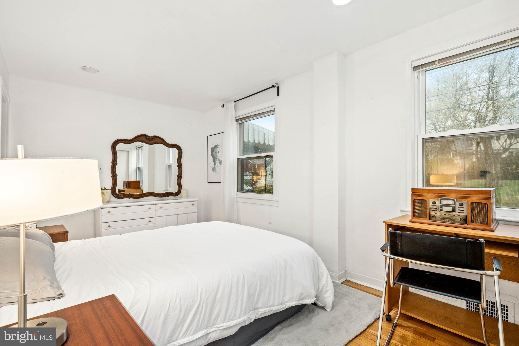 10149 Sutherland Road Silver Spring, MD 20901 - Photo 25 of 31 a bedroom with a bed and dresser with wooden floor