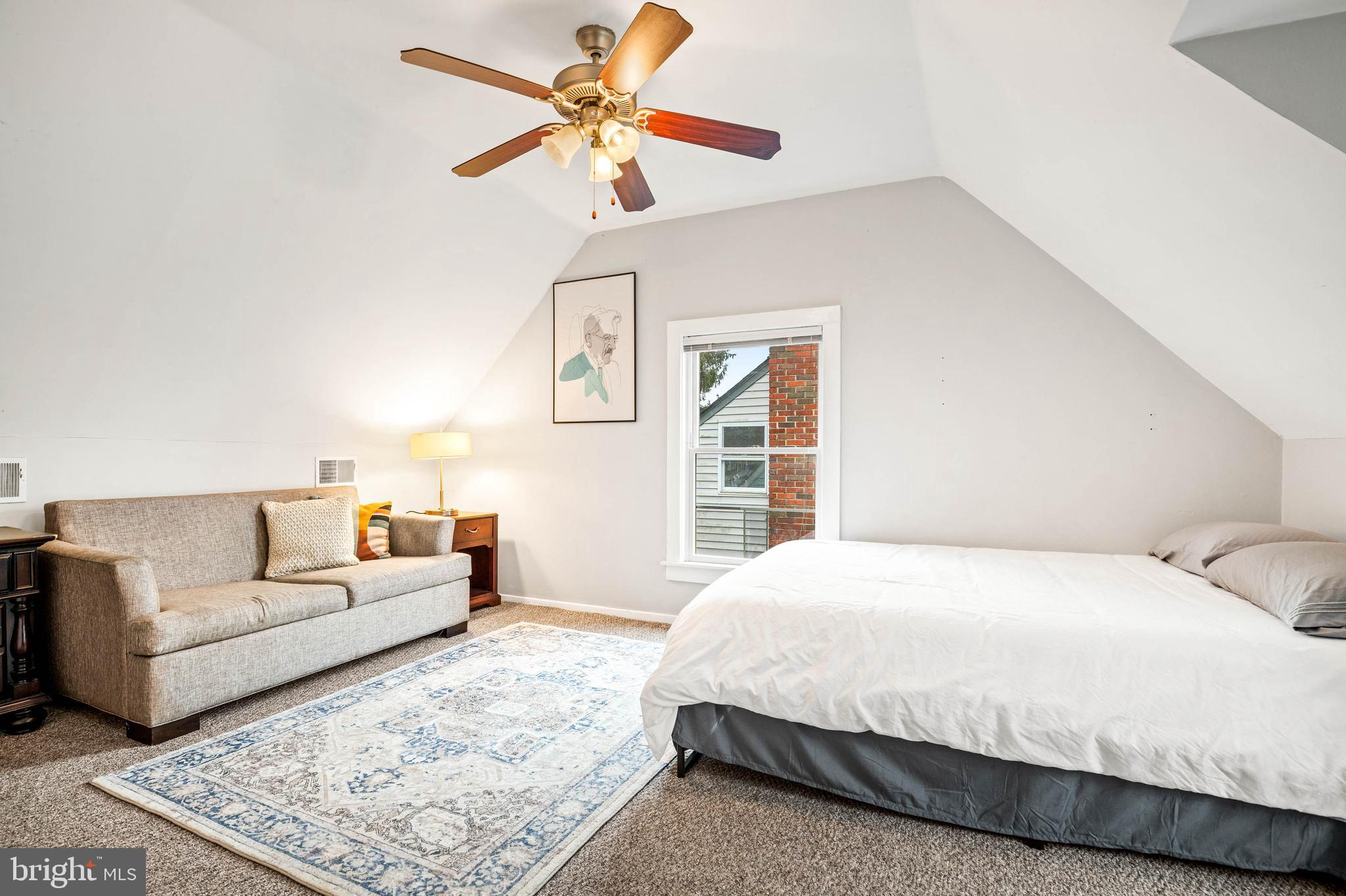 10149 Sutherland Road Silver Spring, MD 20901 - Photo 29 of 31 a bedroom with a large bed couch and a window