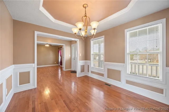 a view of a livingroom with wooden floor and windows
