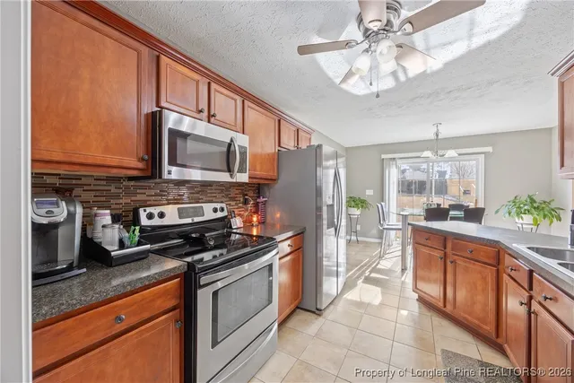 a kitchen with stainless steel appliances a stove microwave and cabinets
