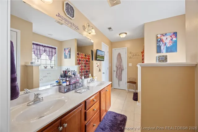 a bathroom with a sink double vanity granite and a shower