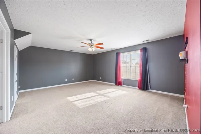 a view of wooden floor and windows in a room