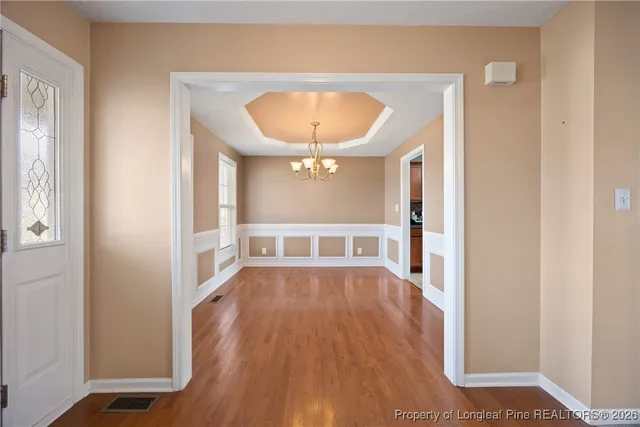 a view of a room with wooden floor and a window