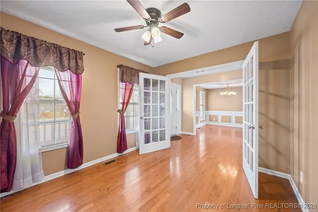 a view of livingroom with hardwood floor and a ceiling fan