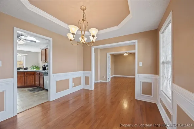 a view of a livingroom with a chandelier furniture and windows