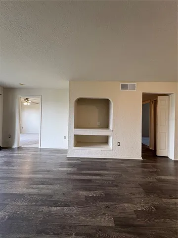 a view of an empty room and wooden floor