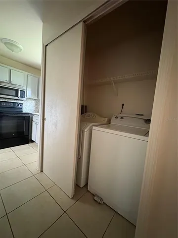 a utility room with cabinets washer and dryer