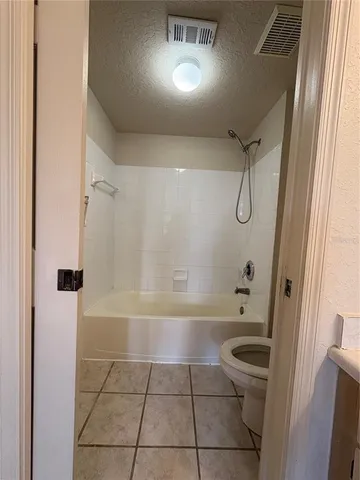 a bathroom with a bathtub a toilet and a shower