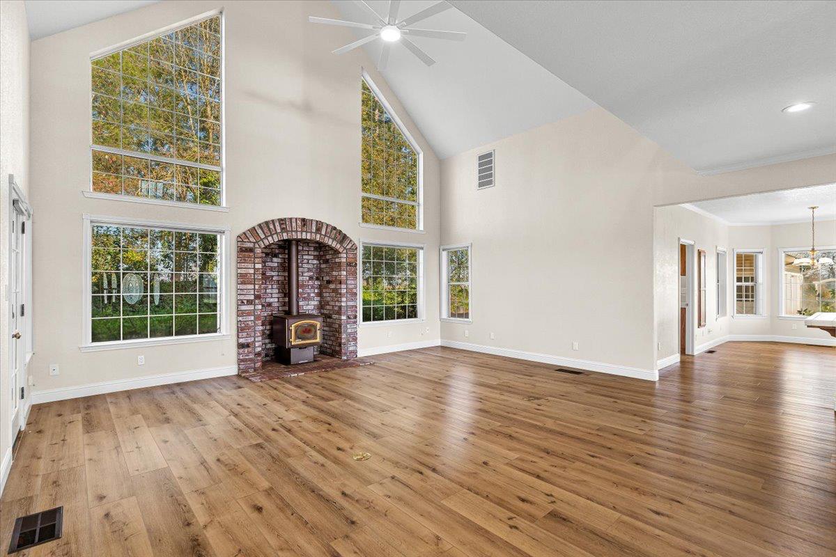 12900 Angrave Road Herald, CA 95638 - Photo 14 of 99 a view of a livingroom with wooden floor and a fireplace