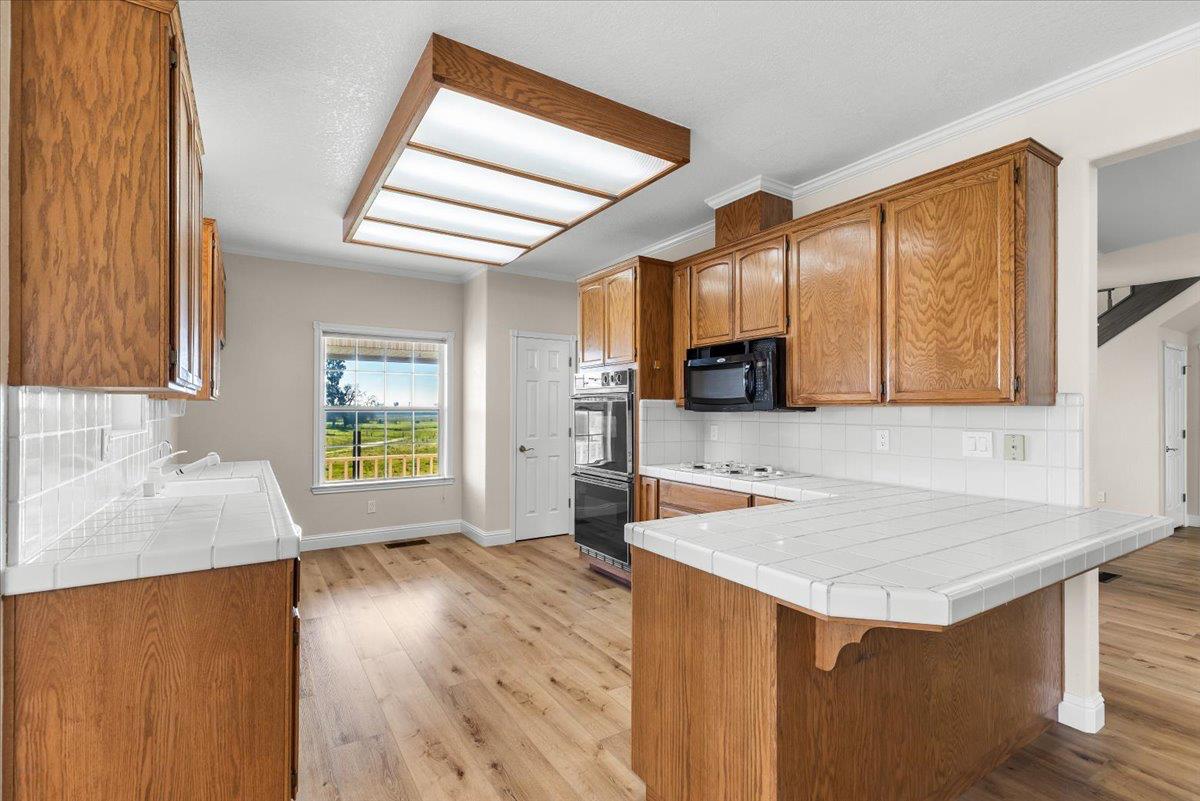12900 Angrave Road Herald, CA 95638 - Photo 24 of 99 a kitchen with a sink cabinets and wooden floor