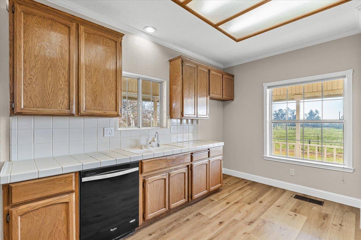 12900 Angrave Road Herald, CA 95638 - Photo 25 of 99 a kitchen with stainless steel appliances granite countertop a sink a stove cabinets and wooden floor