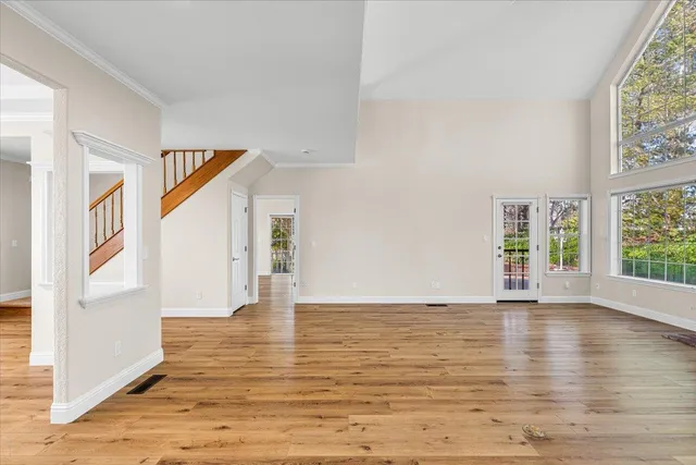 a view of entryway and hall with wooden floor