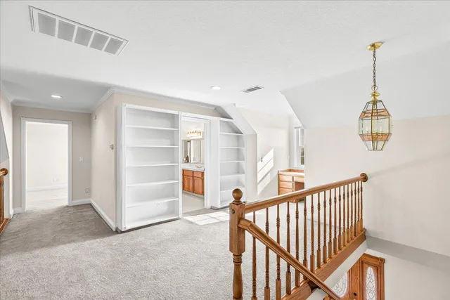 an aerial view of ocean and residential houses with outdoor space