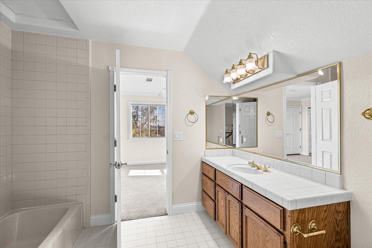 12900 Angrave Road Herald, CA 95638 - Photo 48 of 99 a bathroom with a sink a mirror and a bathtub