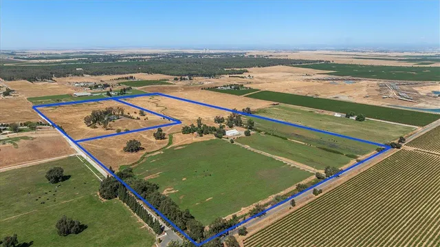 a view of a livingroom with wooden floor and a fireplace