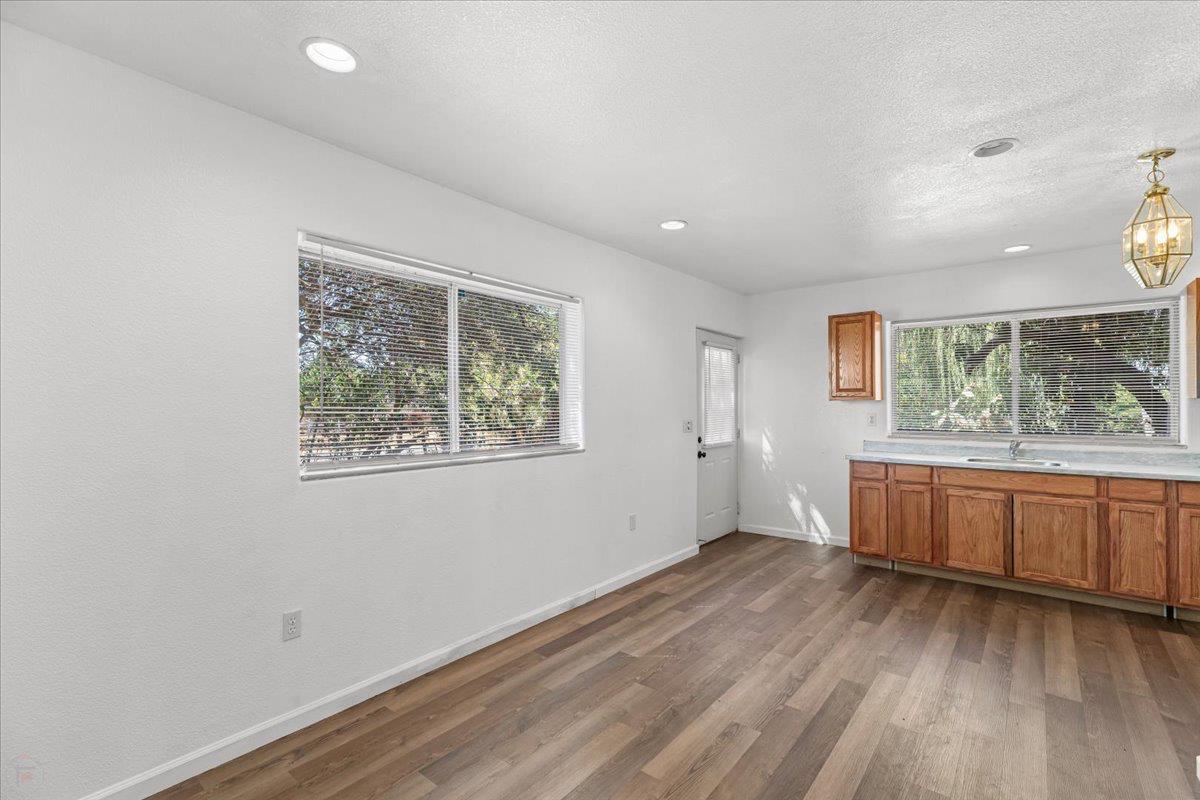 12900 Angrave Road Herald, CA 95638 - Photo 72 of 99 an empty room with wooden floor and windows