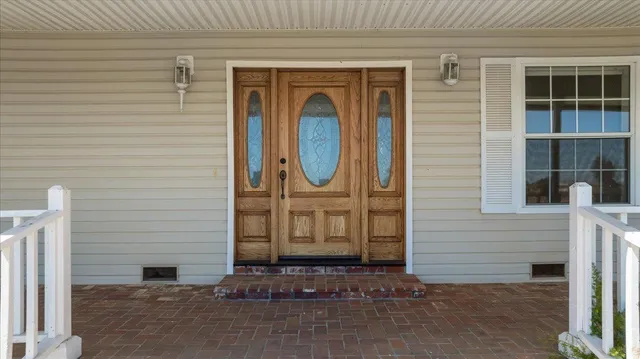 a view of an empty room window and wooden floor