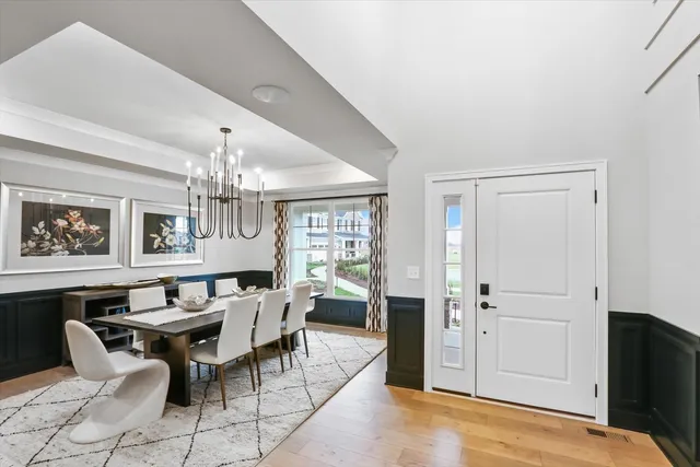 a view of a dining room with furniture and a chandelier