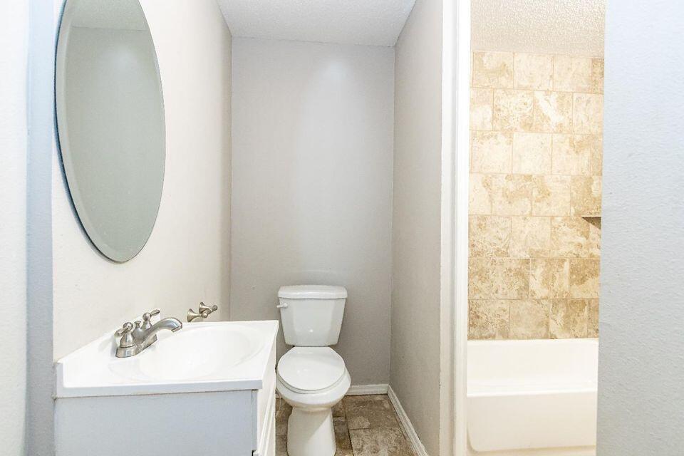 4212 42nd Street Lubbock, TX 79413 - Photo 13 of 18 a bathroom with a sink toilet and a mirror