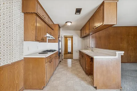 a kitchen with stainless steel appliances granite countertop a stove and a sink