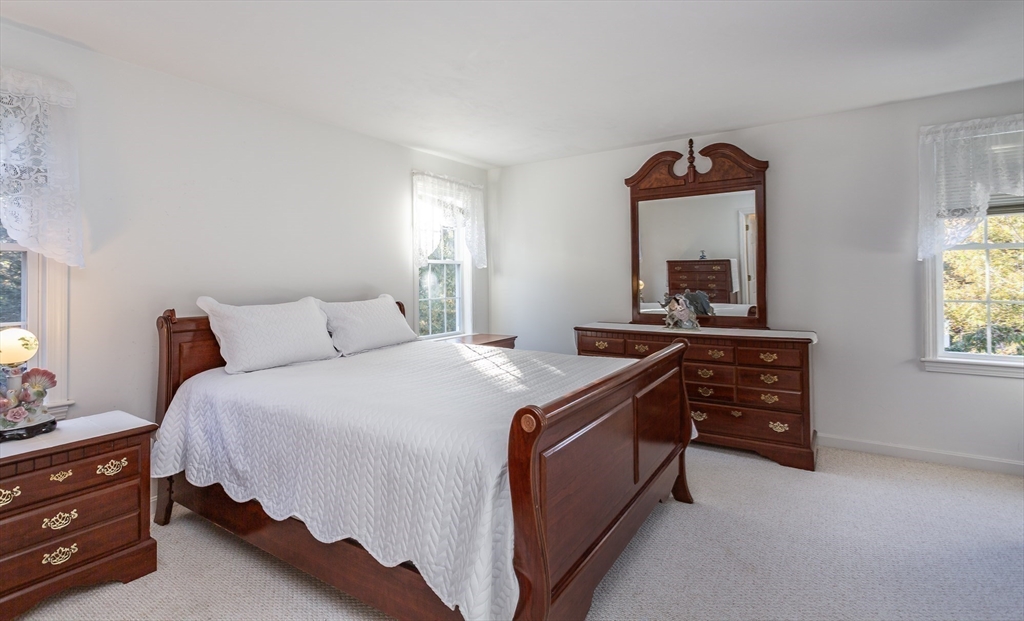 20 Sandy Way Mashpee, MA 02649 - Photo 16 of 33 a bedroom with a bed and a dresser