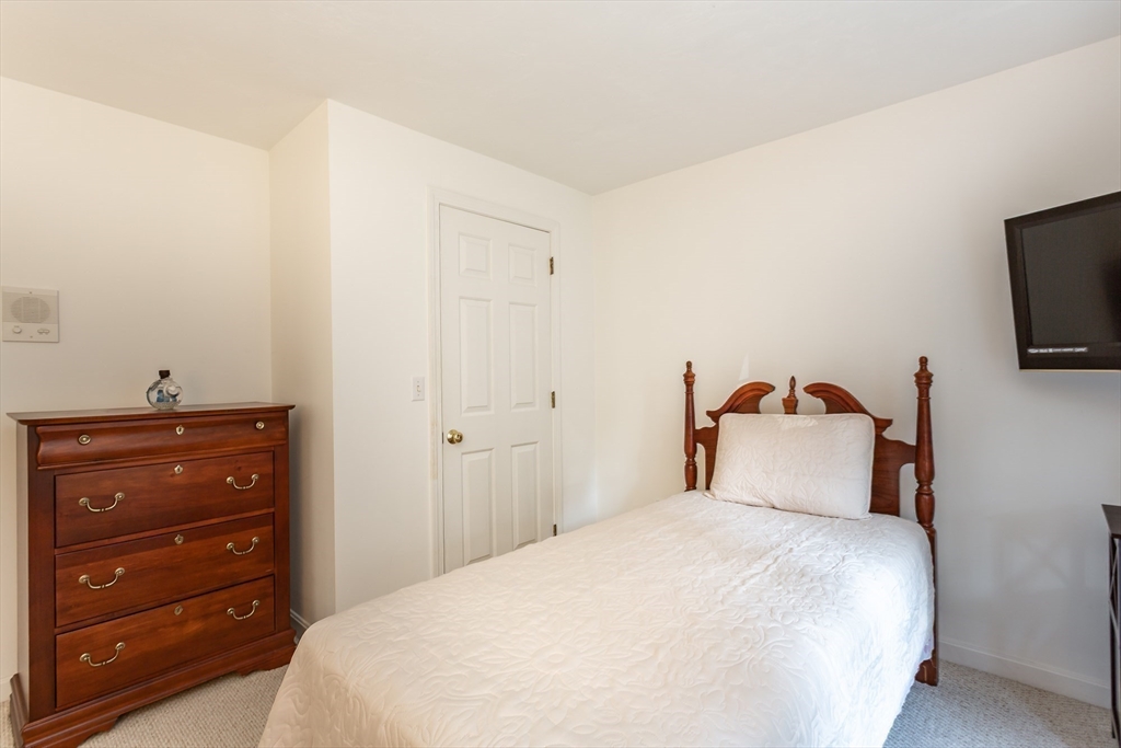 20 Sandy Way Mashpee, MA 02649 - Photo 22 of 33 a bedroom with a bed and a flat tv screen on dresser