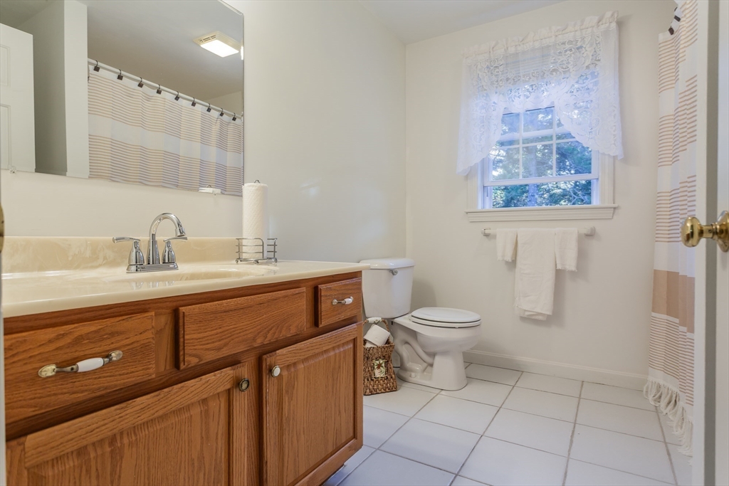 20 Sandy Way Mashpee, MA 02649 - Photo 24 of 33 a bathroom with a toilet a sink and mirror