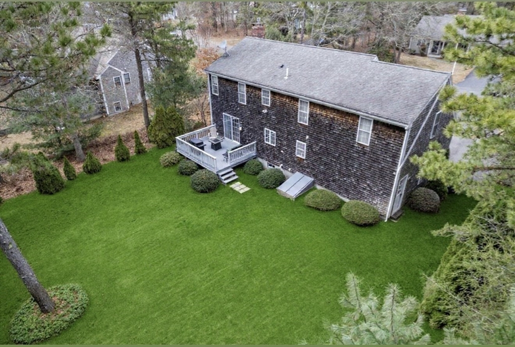 20 Sandy Way Mashpee, MA 02649 - Photo 28 of 33 an aerial view of a house with a yard table and chairs