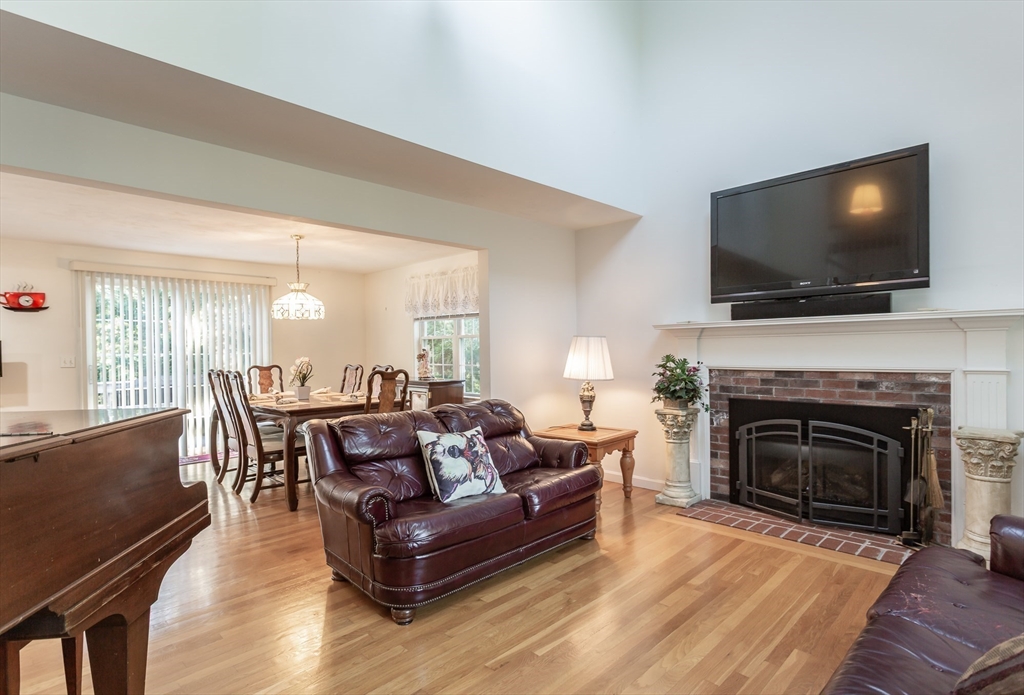 20 Sandy Way Mashpee, MA 02649 - Photo 4 of 33 a living room with furniture a flat screen tv and a fireplace