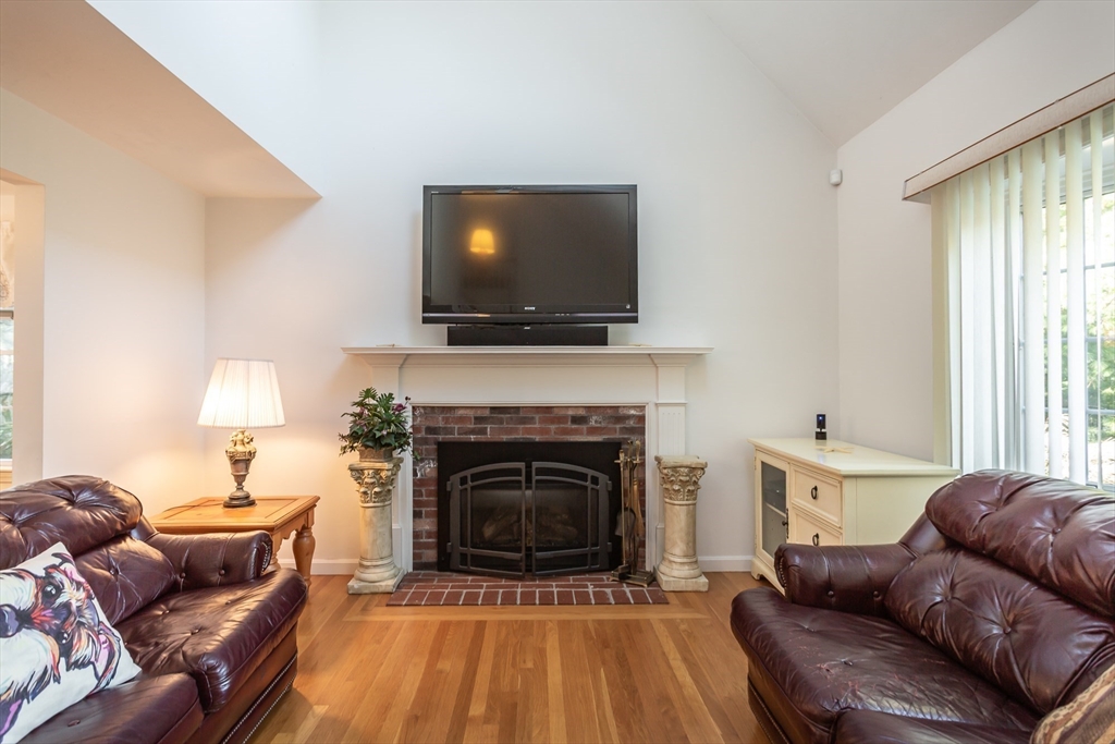 20 Sandy Way Mashpee, MA 02649 - Photo 5 of 33 a living room with furniture a flat screen tv and a fireplace