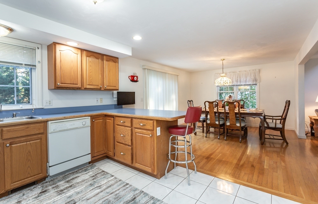 20 Sandy Way Mashpee, MA 02649 - Photo 10 of 33 a kitchen with stainless steel appliances granite countertop sink table and chairs