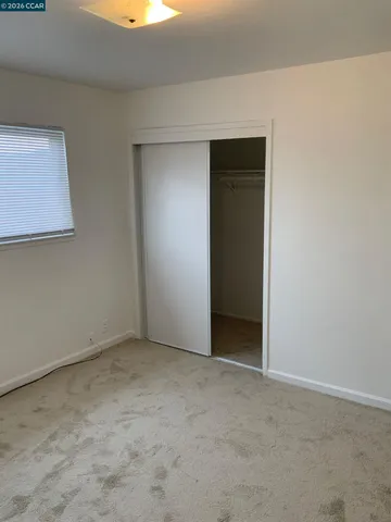 a view of an empty room with closet