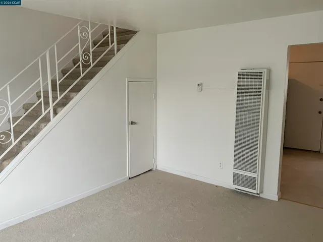 a view of an empty room with stairs