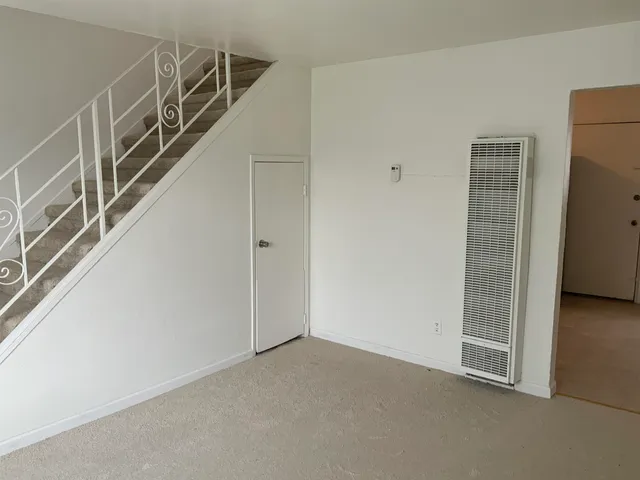 a view of an empty room with stairs