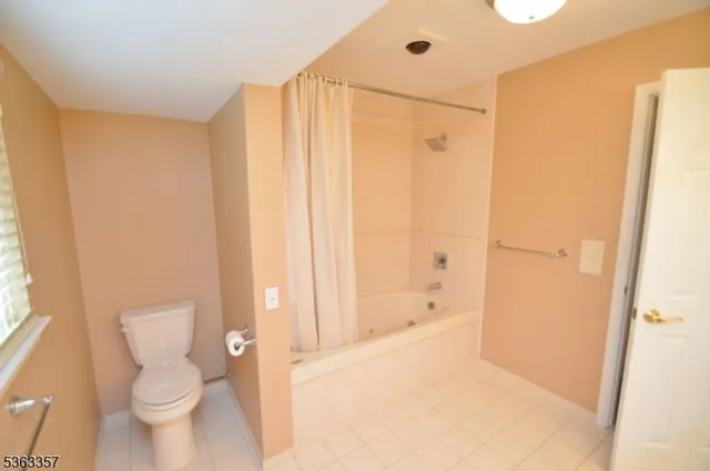 a bathroom with a shower and a toilet