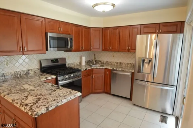 a kitchen with a refrigerator sink and microwave