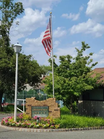 a blue sign that is sitting in the middle of a yard