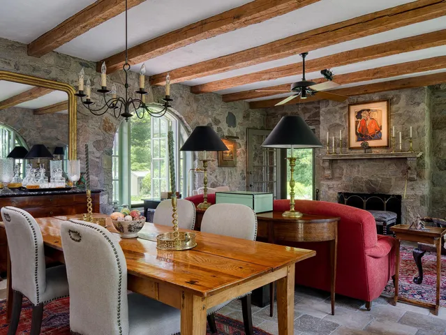 a living room with fireplace furniture and a large window