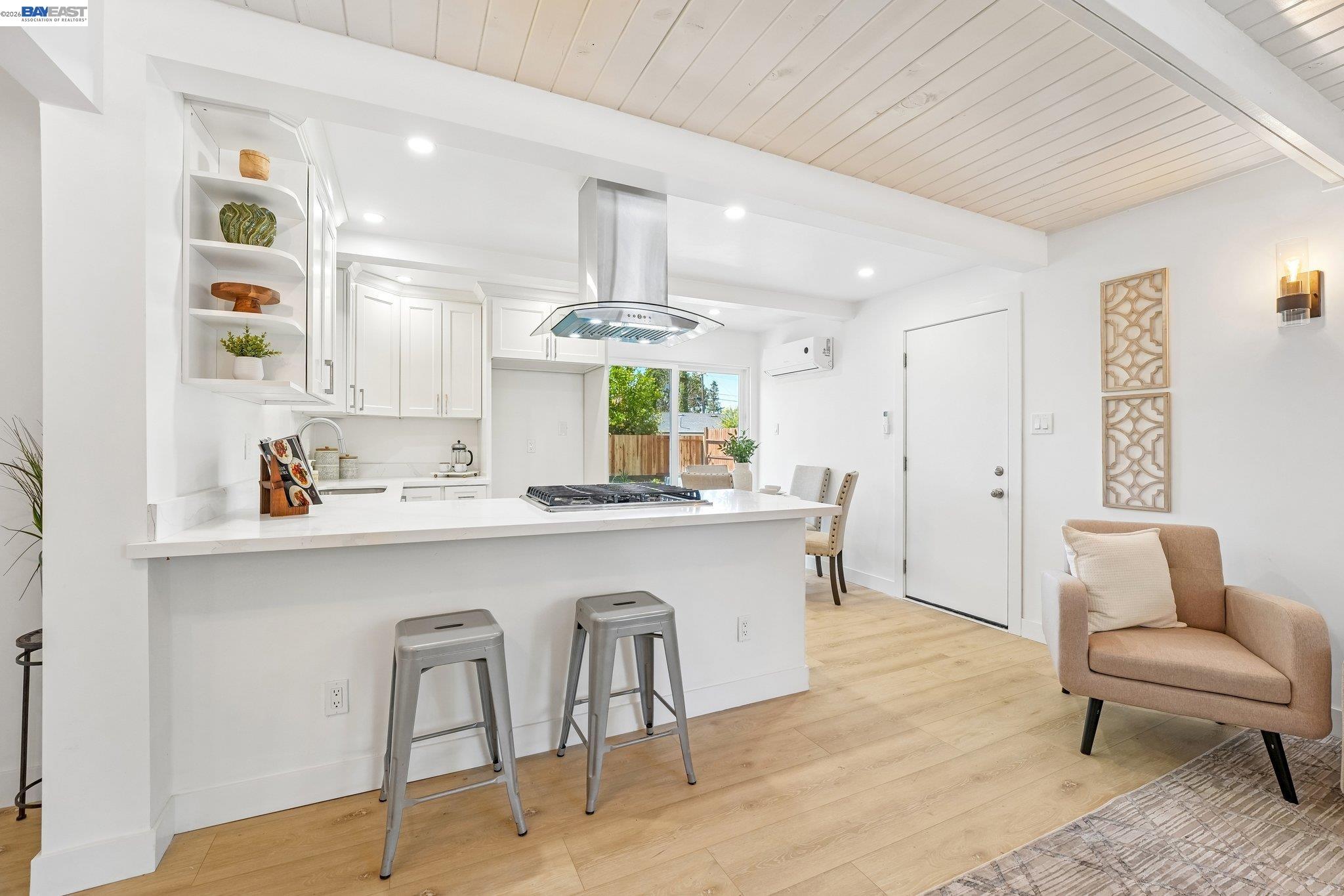606 West 9th Street Santa Rosa, CA 95401 - Photo 22 of 52 a kitchen with stainless steel appliances a white table chairs and a refrigerator