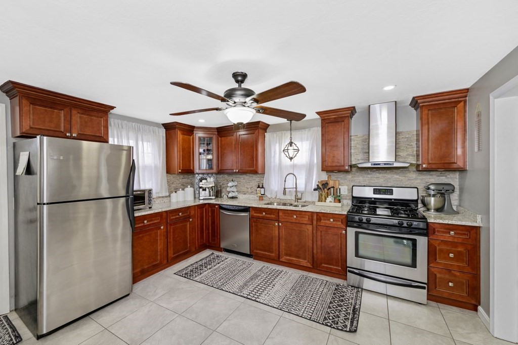 36 Hally Road Lowell, MA 01854 - Photo 12 of 33 a kitchen with stainless steel appliances granite countertop a refrigerator a stove and a sink