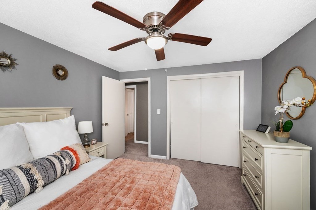 36 Hally Road Lowell, MA 01854 - Photo 16 of 33 a bedroom with a bed ceiling fan and a wooden floor