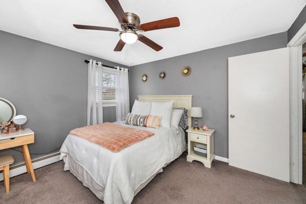 36 Hally Road Lowell, MA 01854 - Photo 18 of 33 a bedroom with a bed and a chandelier