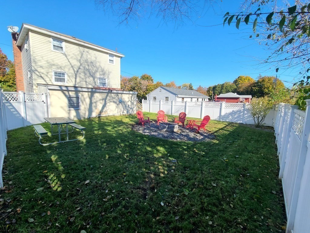 36 Hally Road Lowell, MA 01854 - Photo 29 of 33 a view of a house with a backyard and a porch